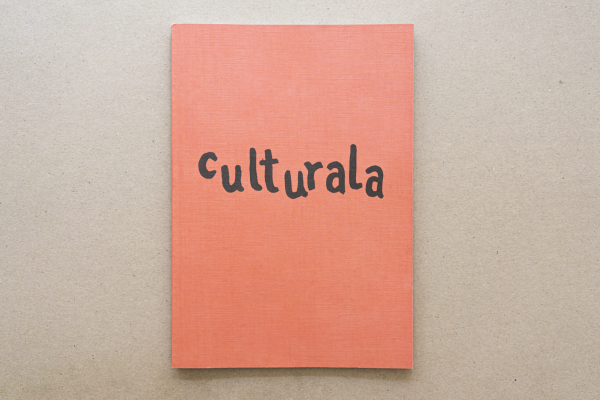 Cover of Culturala #1 in culturala pink with corner open showing text and artwork